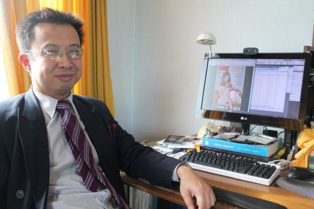 Jack yan at his desk hub for the Lucire Fashion Magazine 
